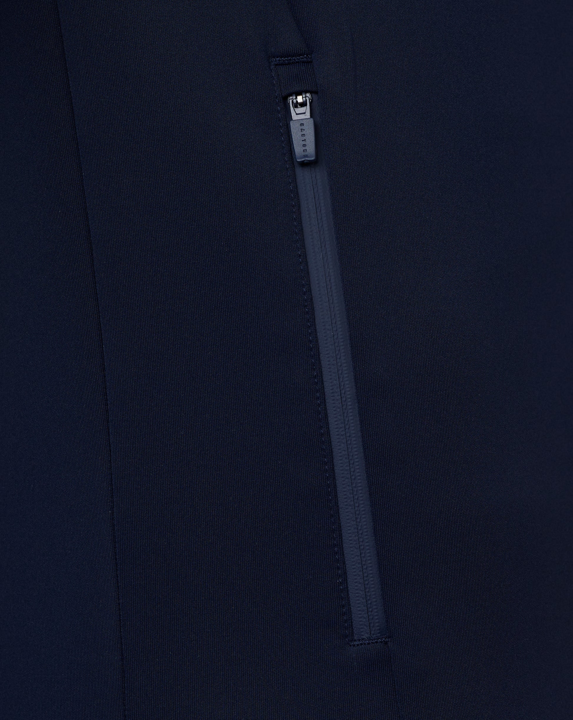 Close-up of a navy blue zipper on a dark background