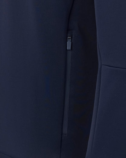 Navy blue coat with a zipper detail on a dark background