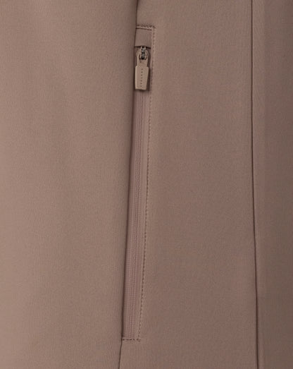 Close-up of a beige fabric with a zipper and brand label.