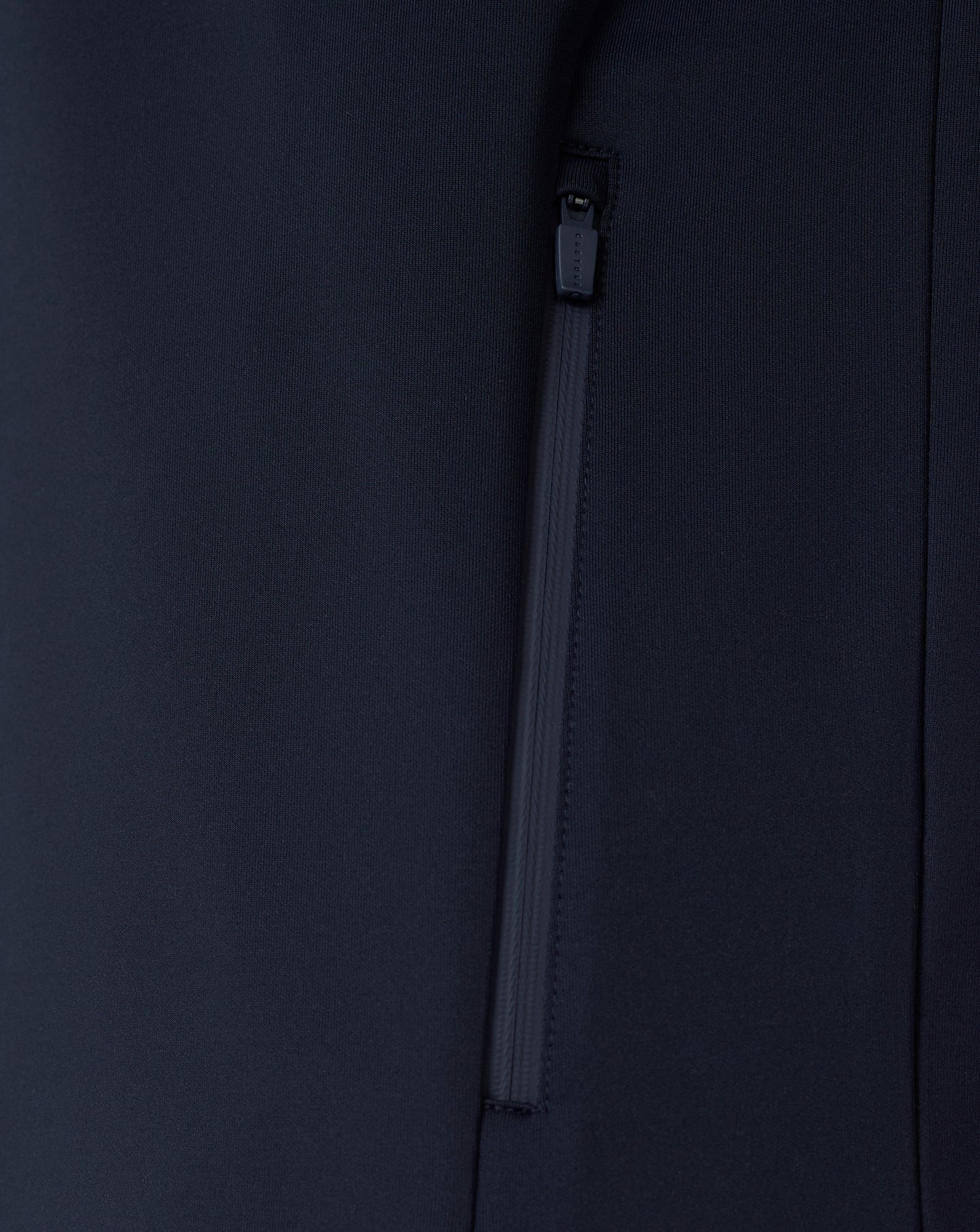 Close-up of a black jacket with a zipper on a dark background