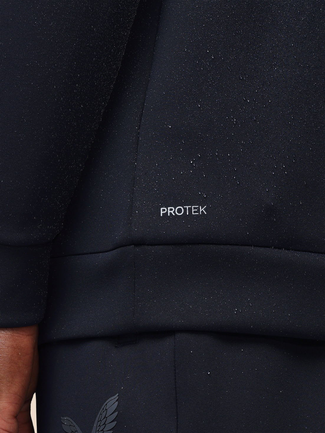 Black jacket with 'PROTEK' branding on the chest