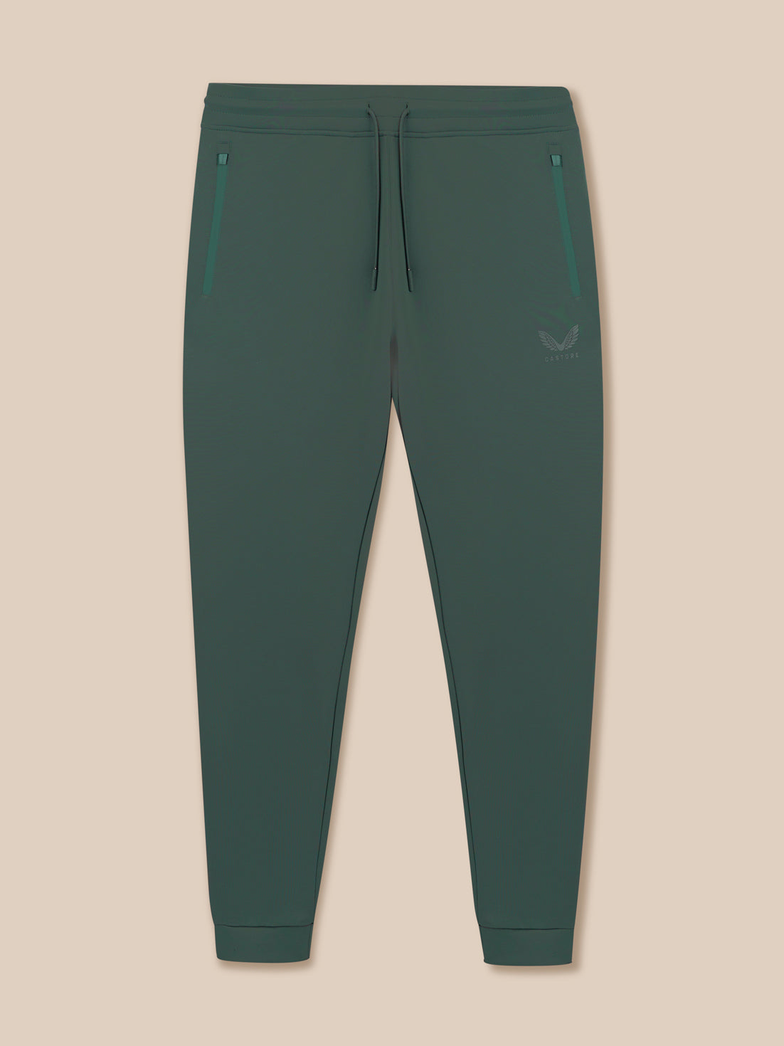 Green jogger pants on a beige background