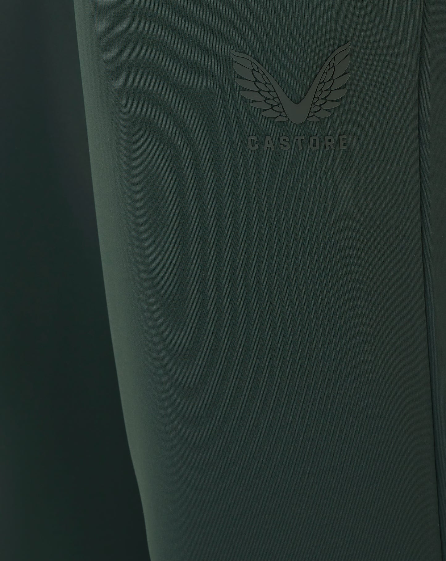 Dark green product with 'CASTORE' branding on a dark background