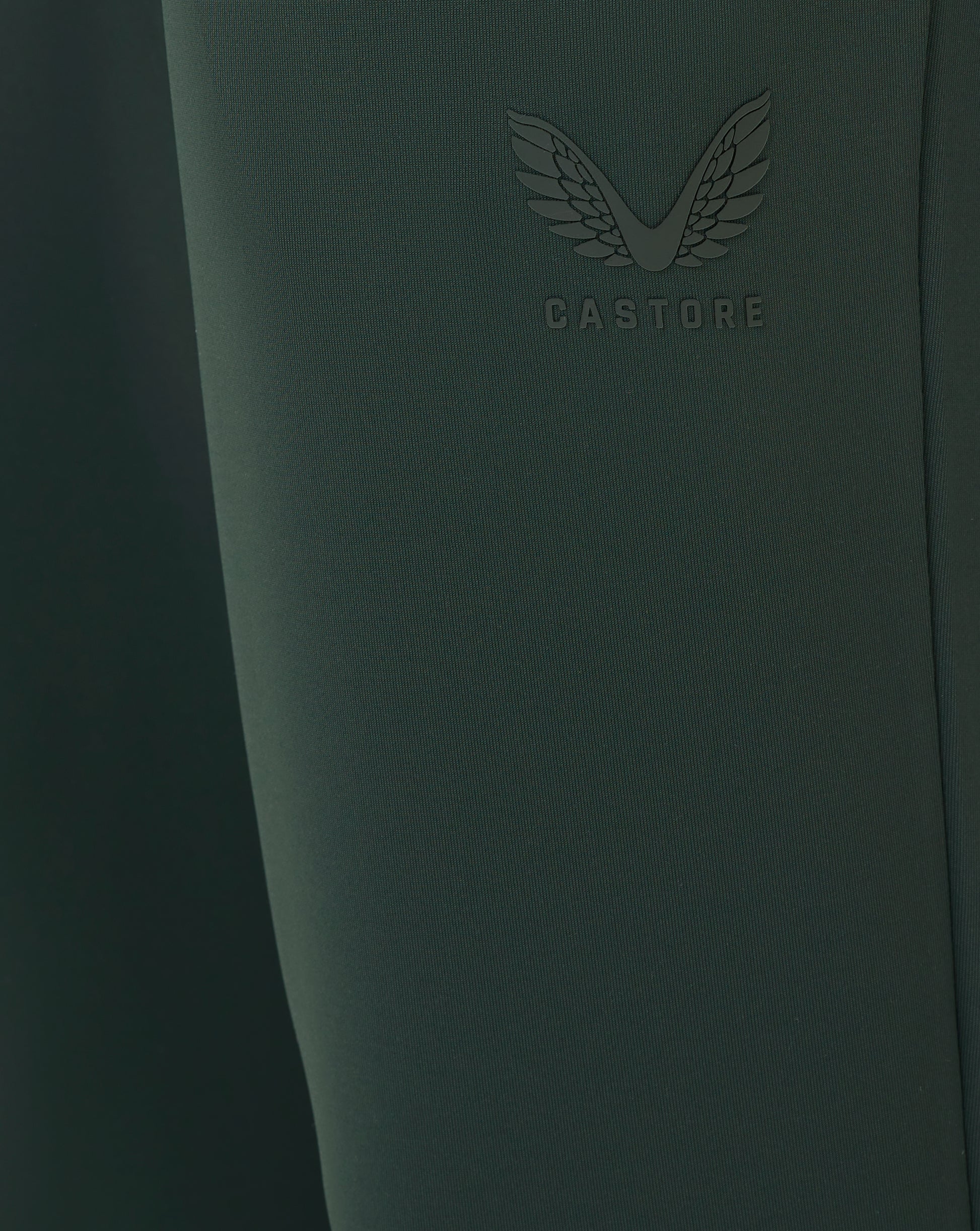 Dark green product with 'CASTORE' branding on a dark background