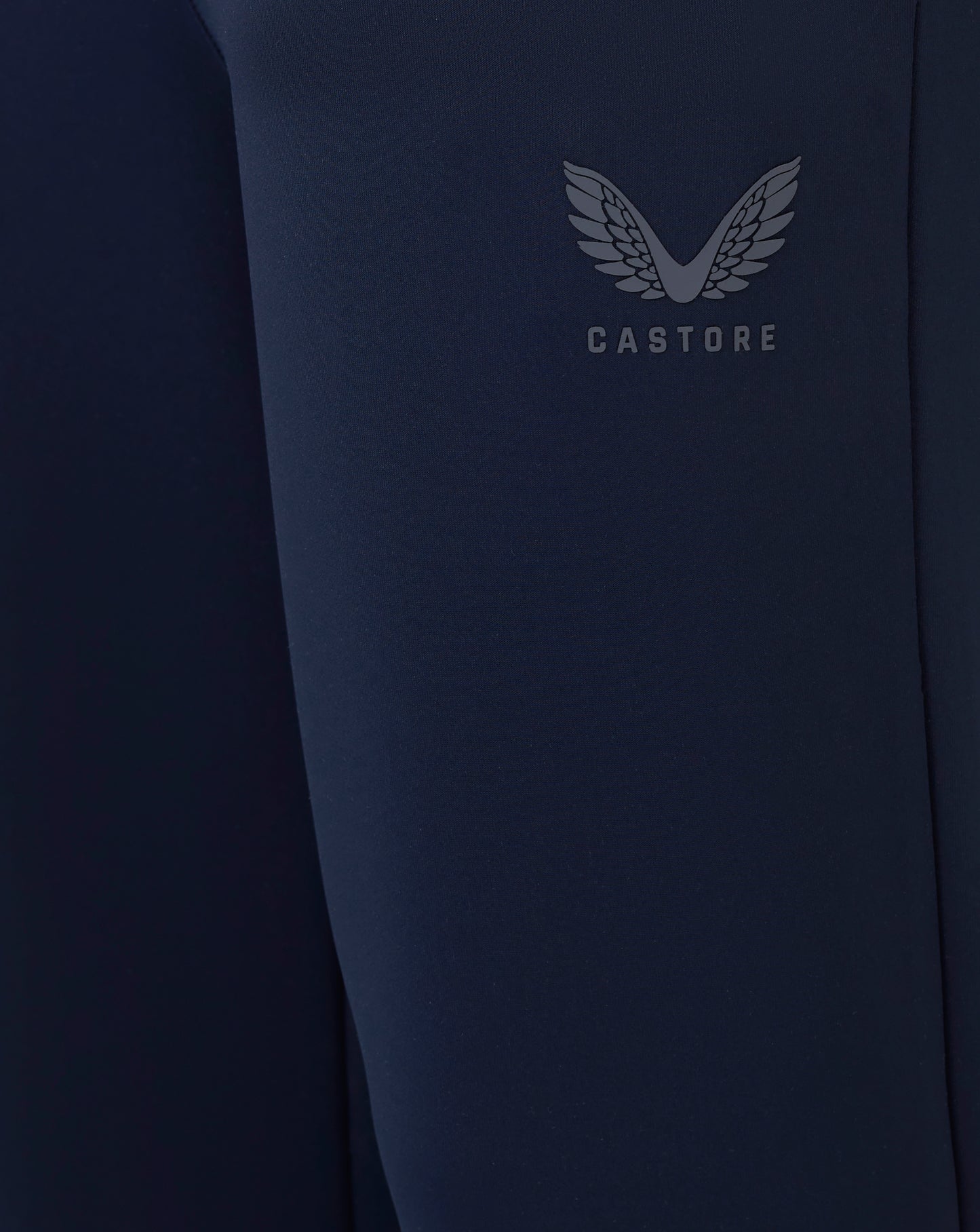 Navy blue sleeve with Castore logo on a dark background
