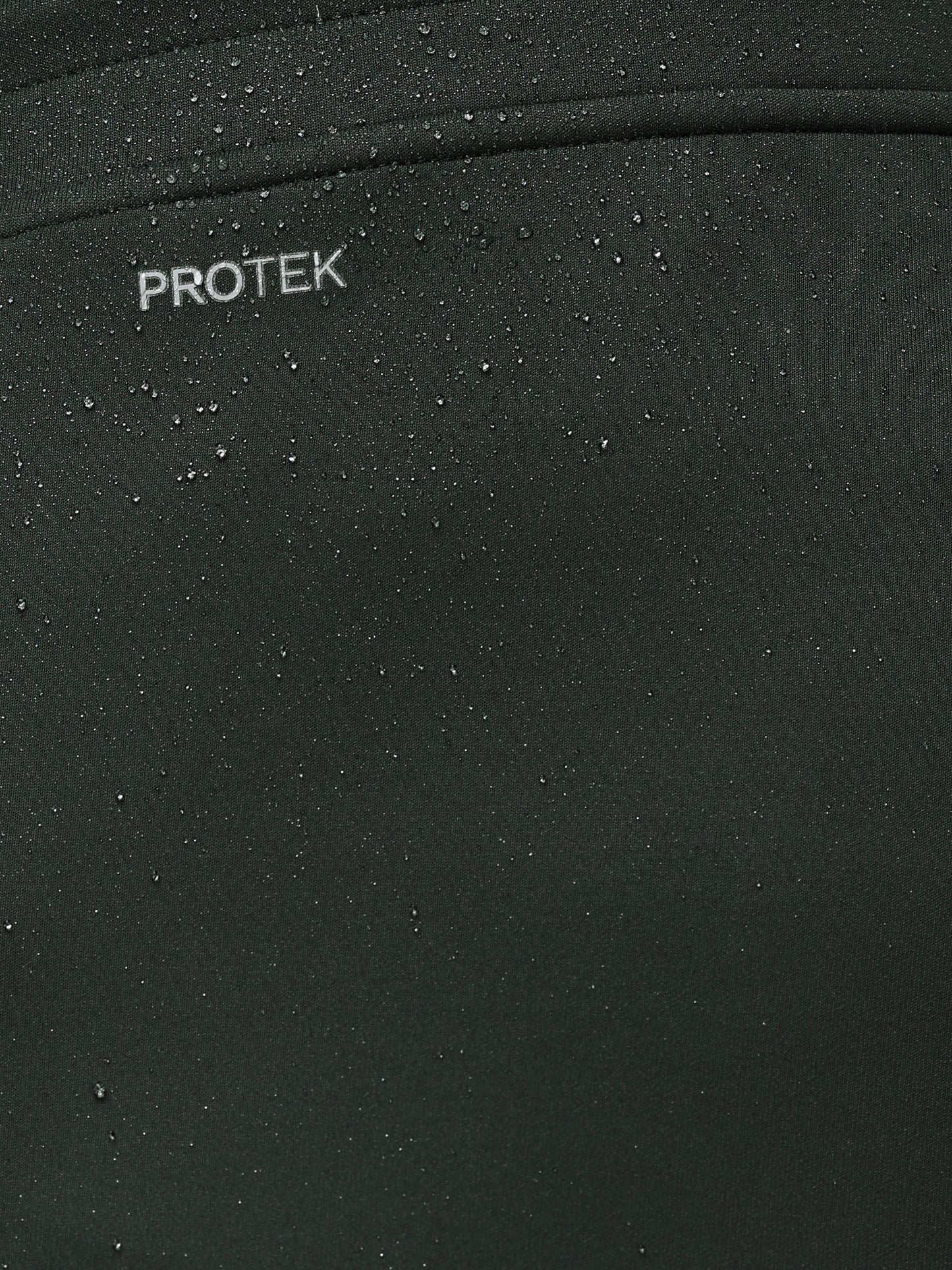 Close-up of a black surface with 'PROTEK' branding.