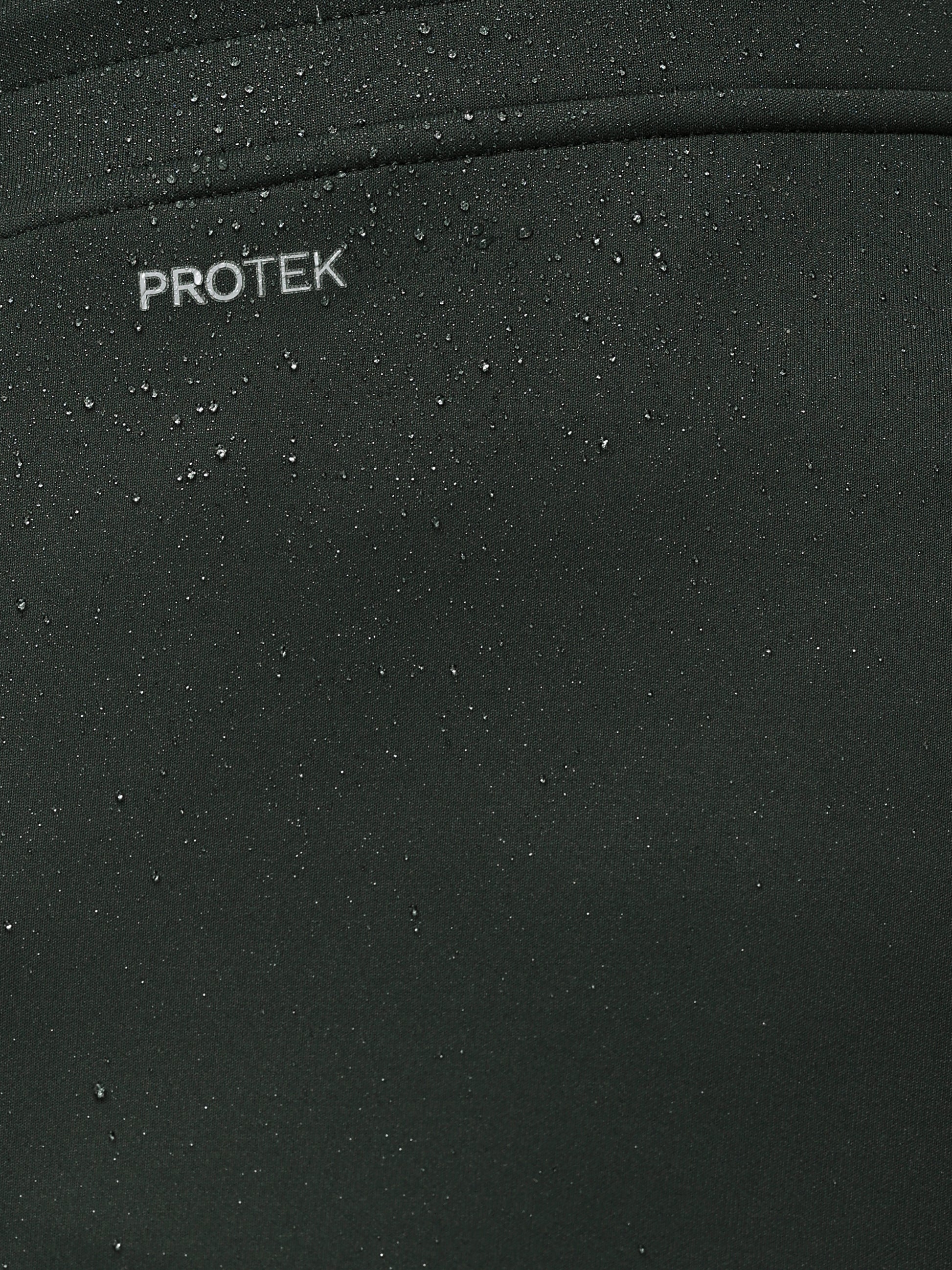 Close-up of a black surface with 'PROTEK' branding.