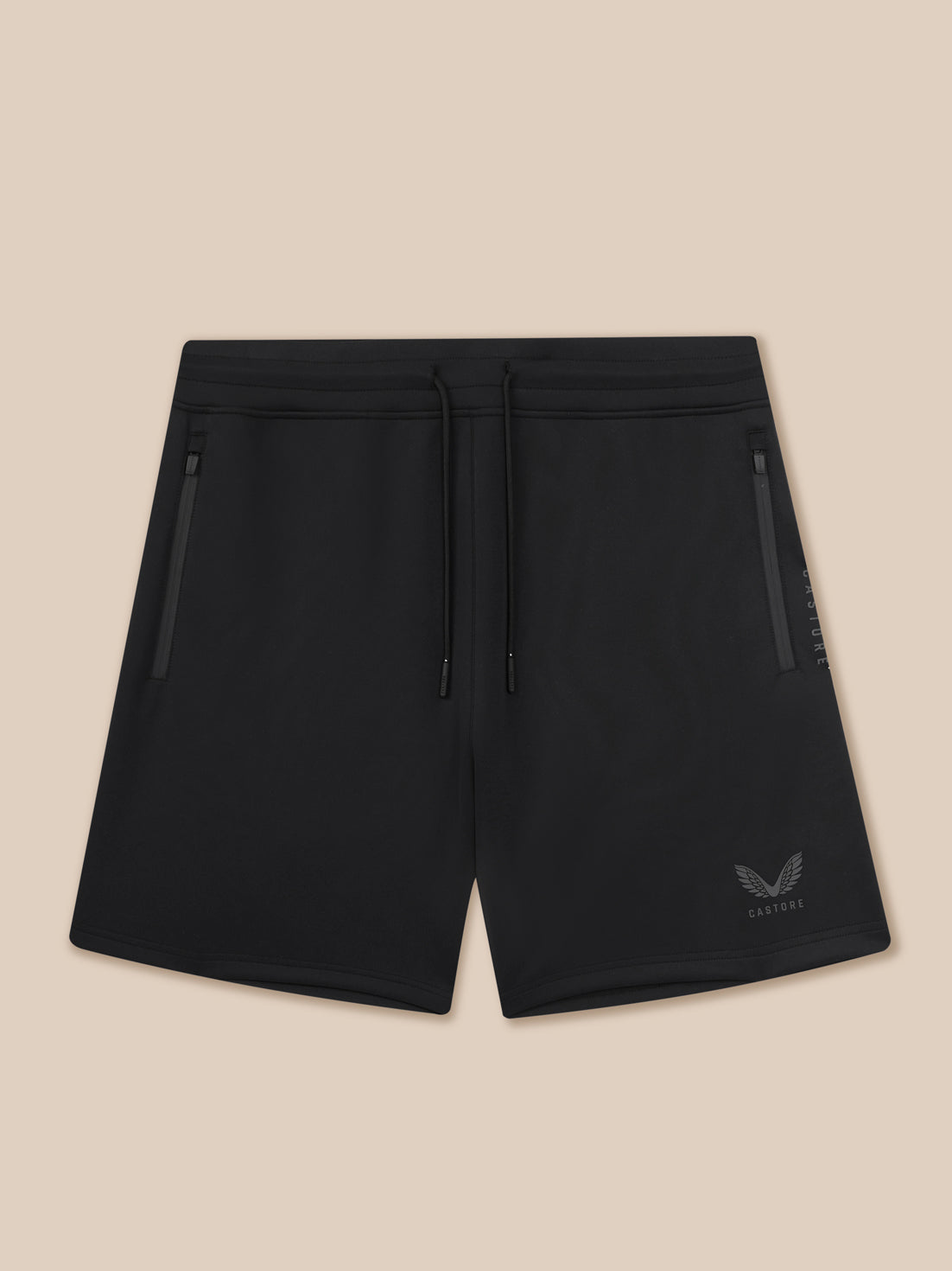 Black shorts with a brand logo on a beige background
