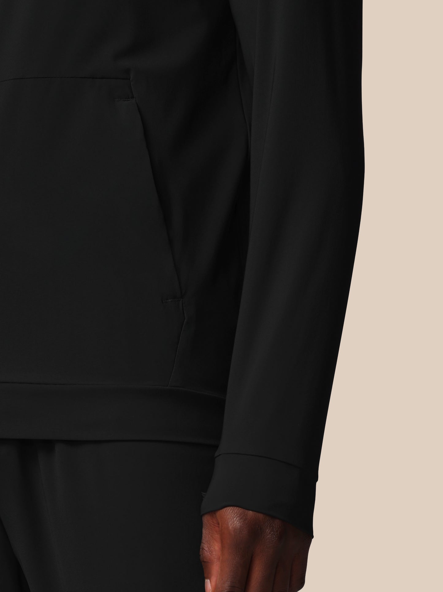 Close-up of a black long-sleeve shirt on a beige background