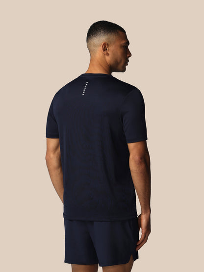 Man wearing a navy blue athletic outfit on a beige background