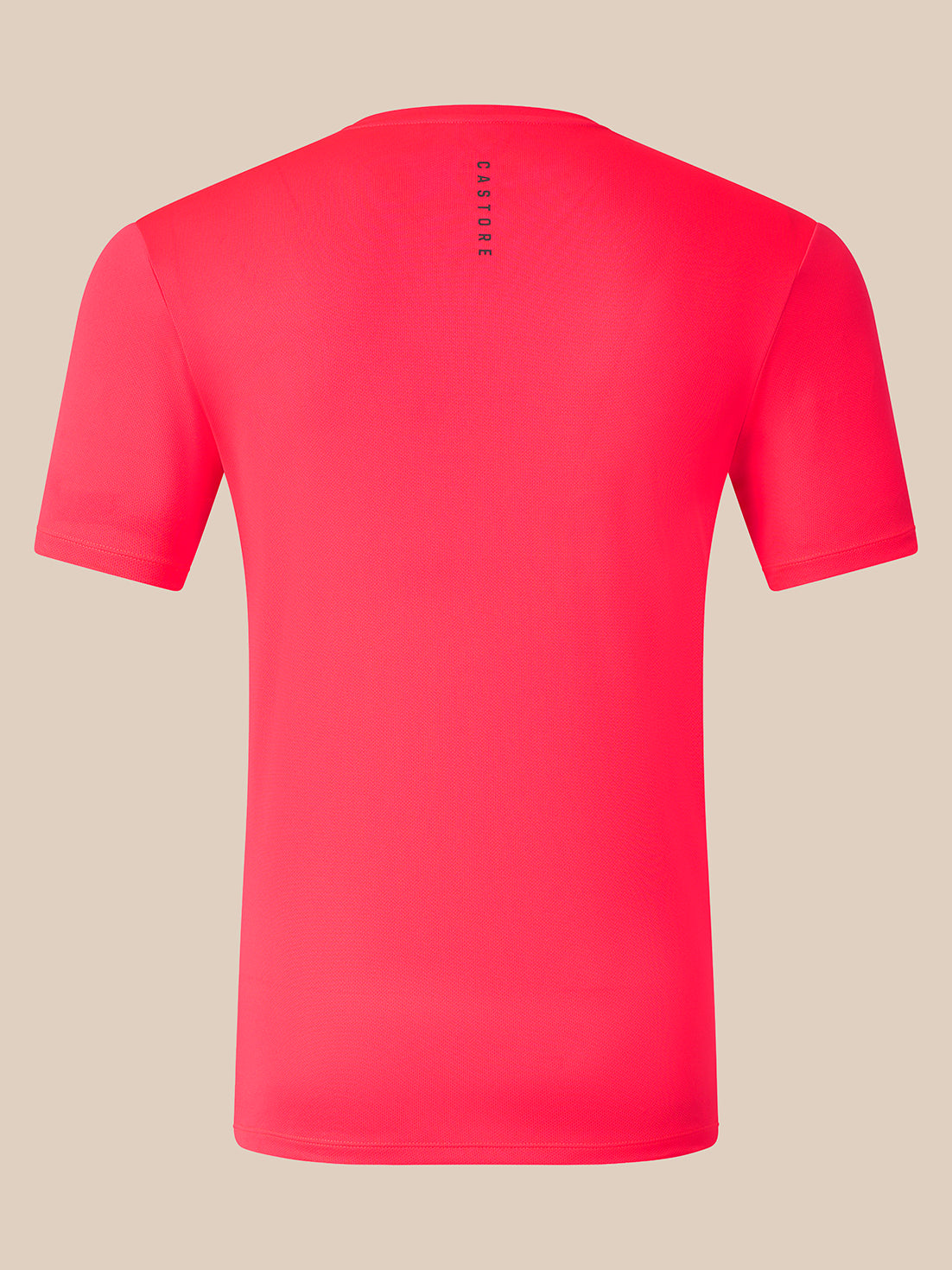 A bright pink short-sleeve athletic t-shirt shown from the back, featuring a vertical black 'CASTORE' logo printed on the upper back, set against a solid beige background.