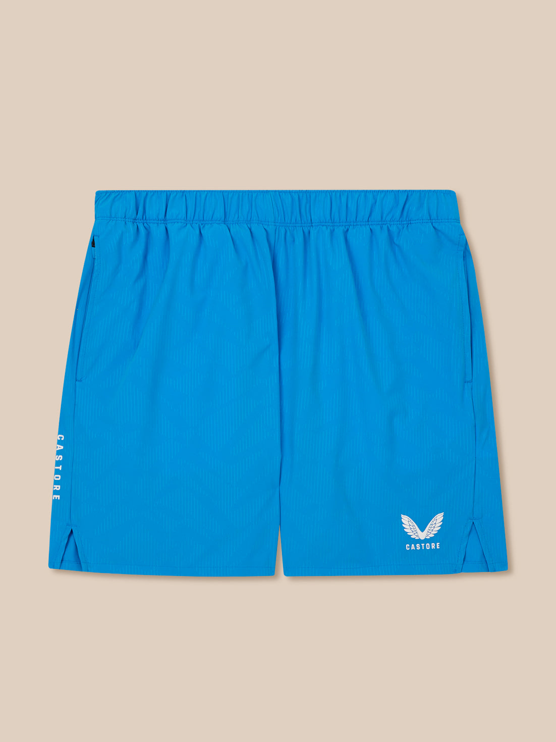 Blue athletic shorts with a logo on a beige background
