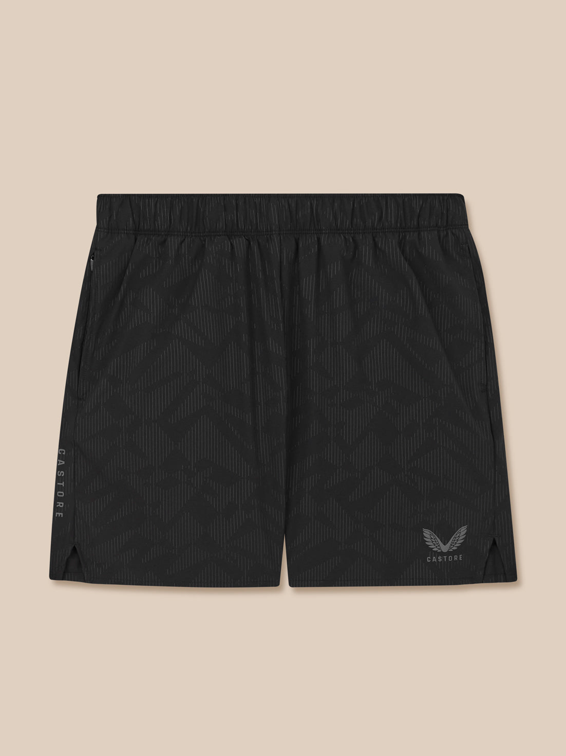 Black athletic shorts with a logo on a beige background