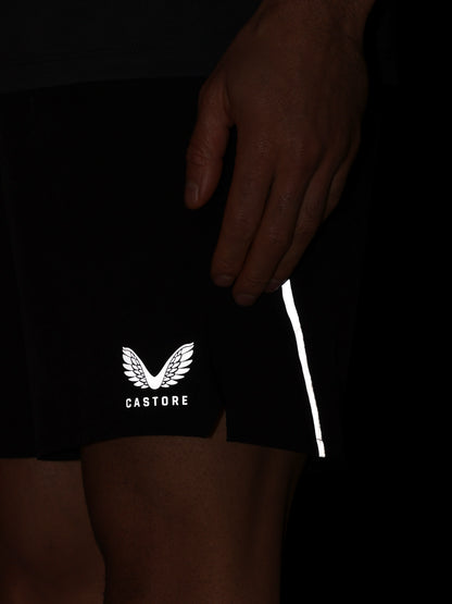 Black shorts with a white logo and text on a dark background
