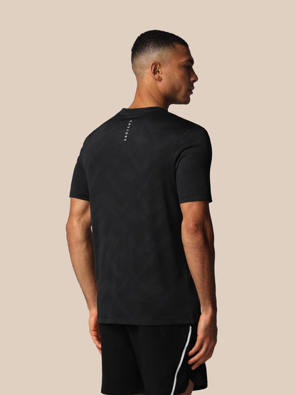 Man wearing a black t-shirt and shorts on a beige background