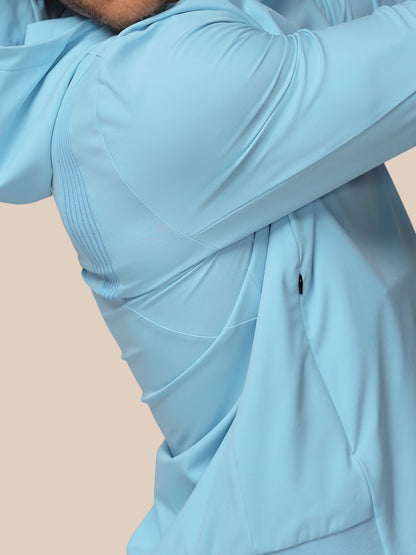 Light blue jacket worn by a person on a beige background