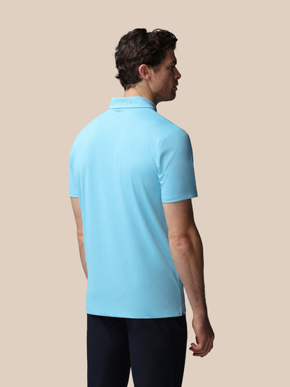 Man wearing a light blue polo shirt on a beige background