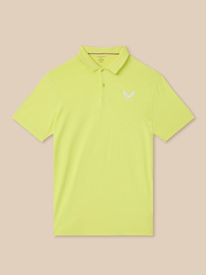 Yellow polo shirt with a logo on a beige background