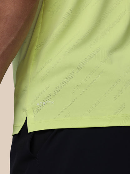 Close-up of a green athletic shirt with Castore logo on a beige background