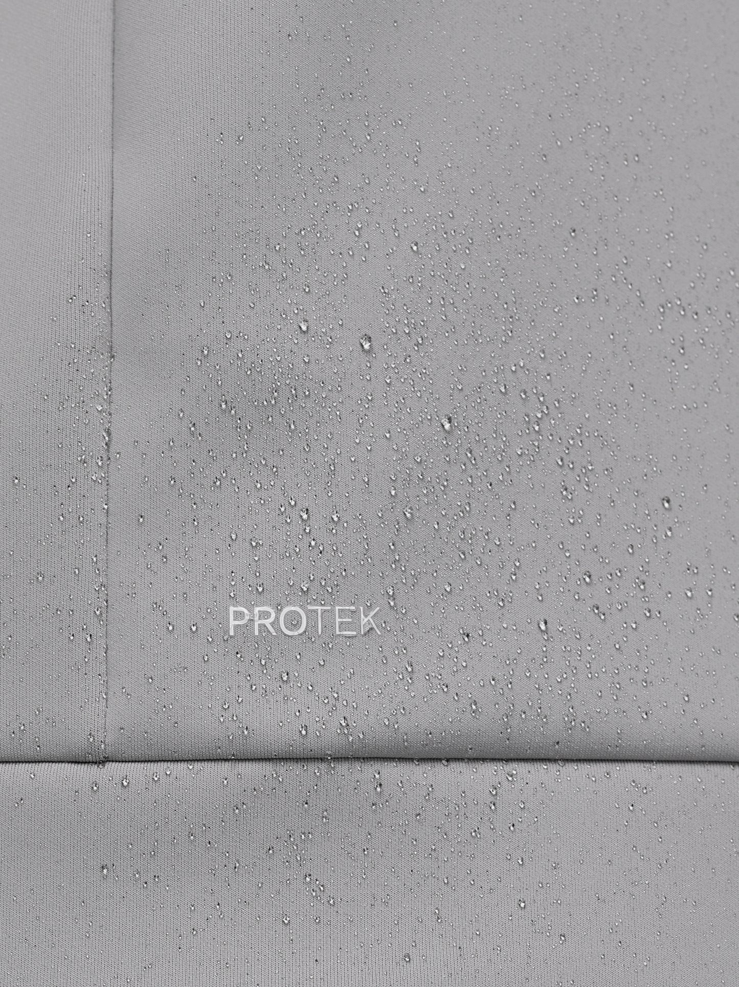 Close-up of a gray concrete surface with 'PROTEK' branding.