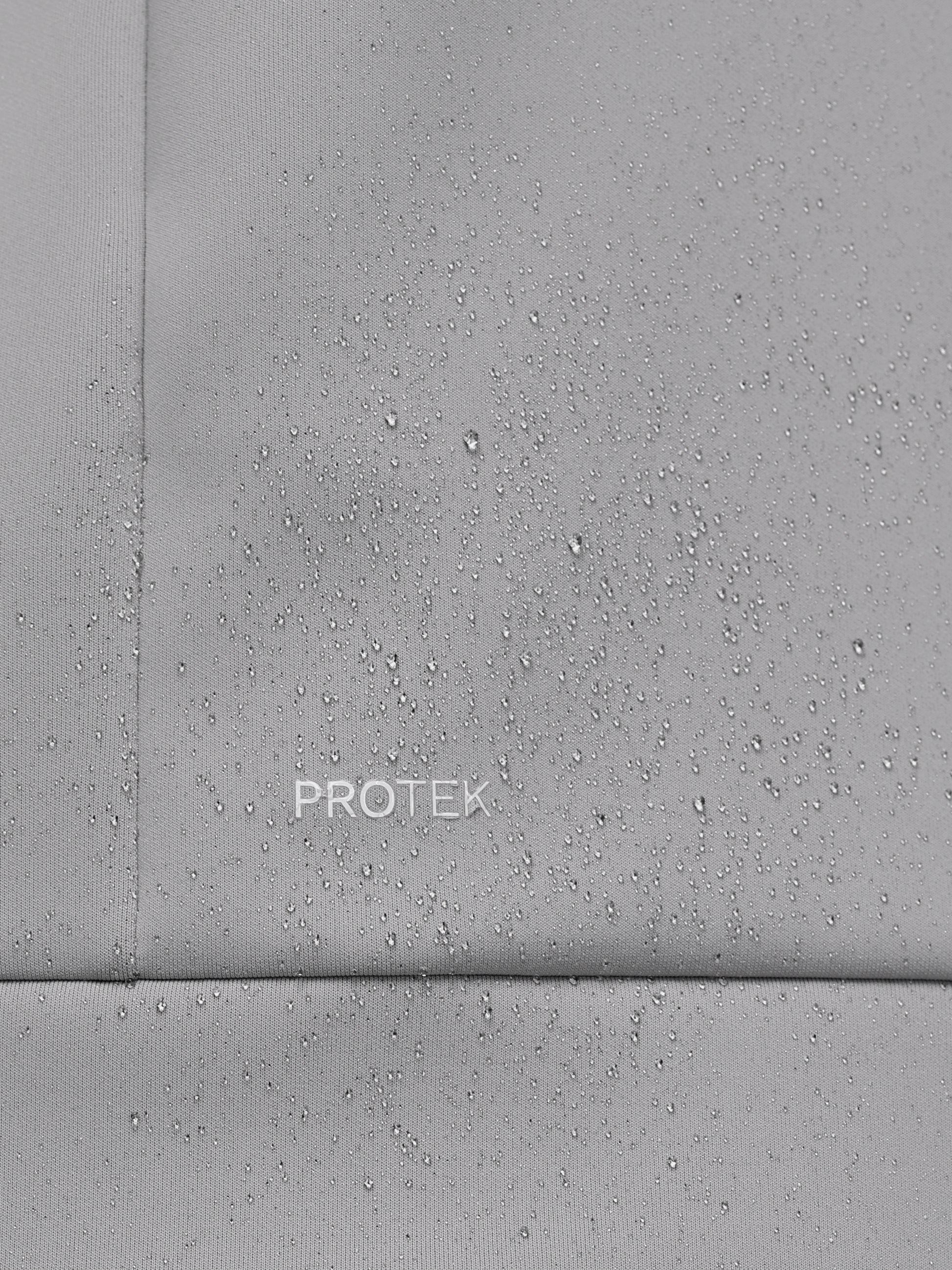 Close-up of a gray concrete surface with 'PROTEK' branding.