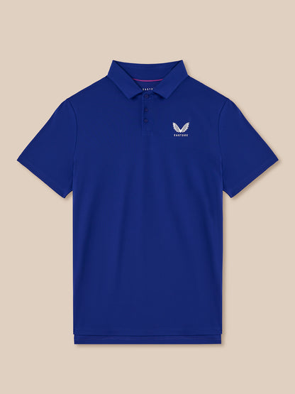 Blue polo shirt with a logo on a beige background
