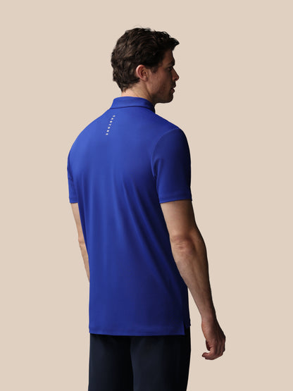 Man wearing a blue polo shirt on a beige background
