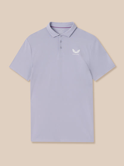Light blue polo shirt with a logo on a beige background