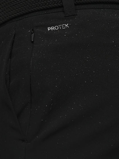 Close-up of a black jacket with 'PROTEK' branding on a textured background