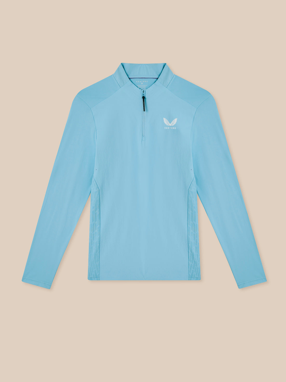 Light blue long-sleeve shirt with a brand logo on a beige background