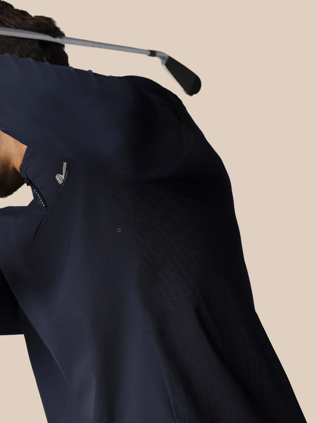 Navy blue shirt against a beige background
