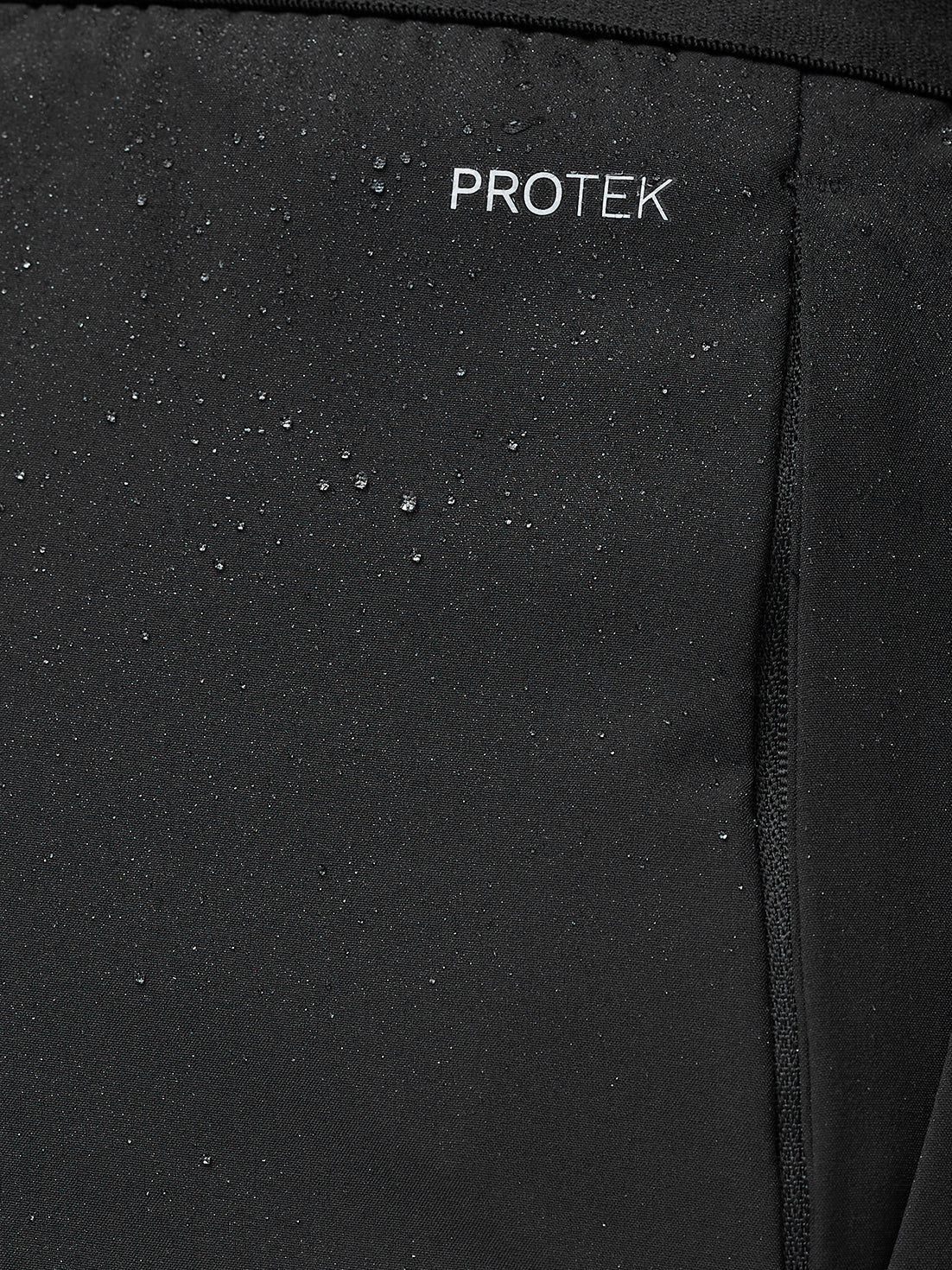 Black fabric with 'PROTEK' branding on a close-up shot
