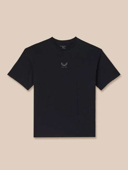 Black t-shirt with a small logo on a beige background