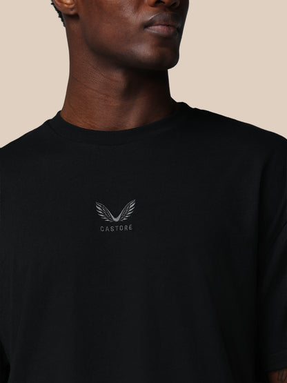 Black t-shirt with a logo and text on a beige background