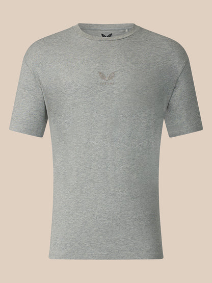 A heather gray short-sleeve crewneck t-shirt with a small tonal embroidered eagle logo and the word 'CASTORE' on the center chest, displayed against a solid light beige background.