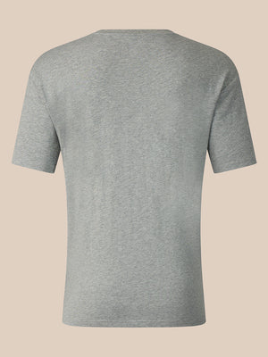 A light gray heather short-sleeve t-shirt shown from the back, displayed on a solid beige background.