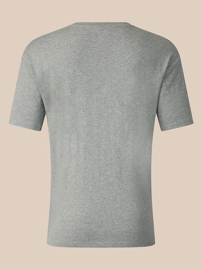 A light gray heather short-sleeve t-shirt shown from the back, displayed on a solid beige background.