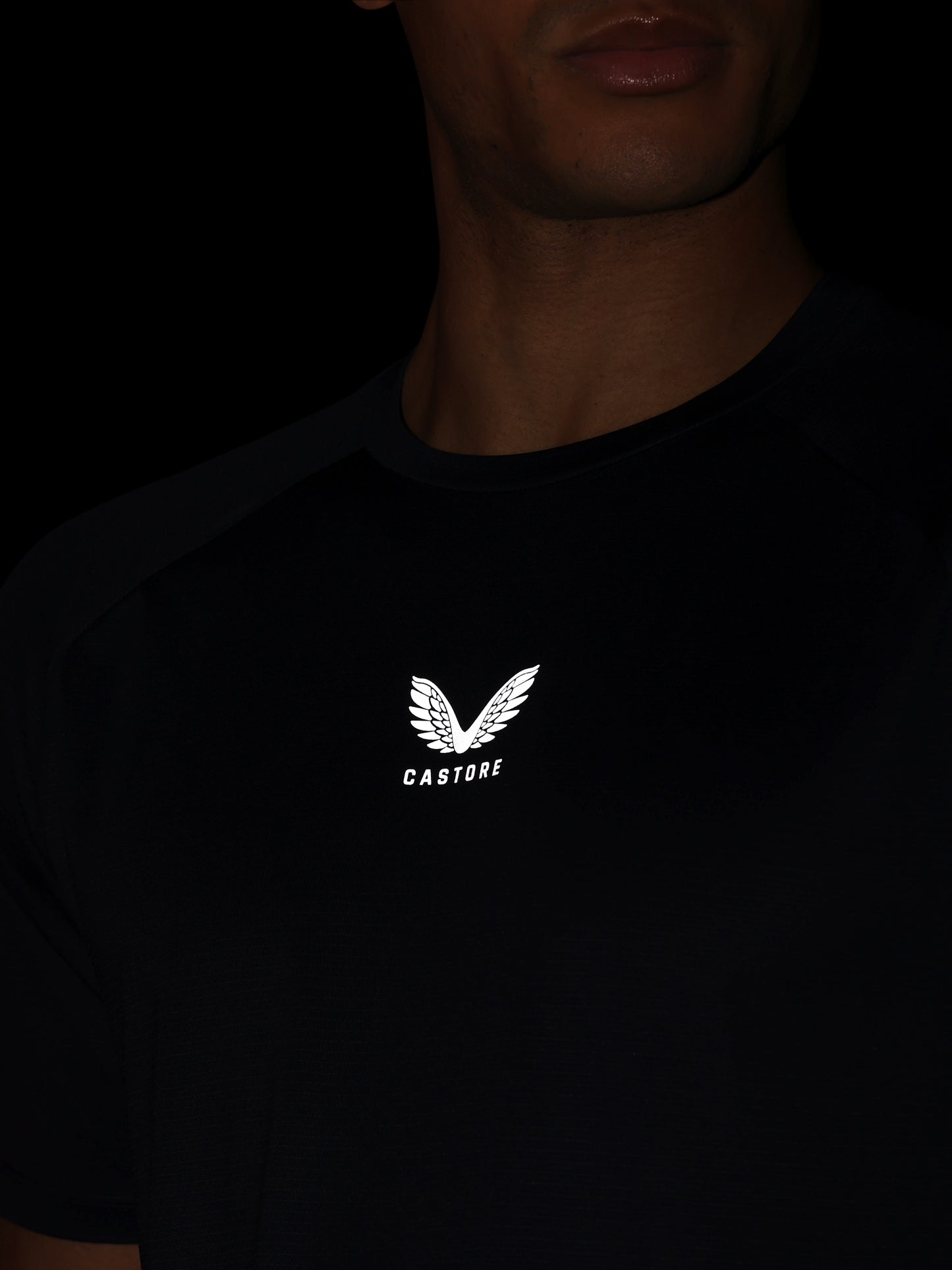 Black t-shirt with a white logo and text on a dark background