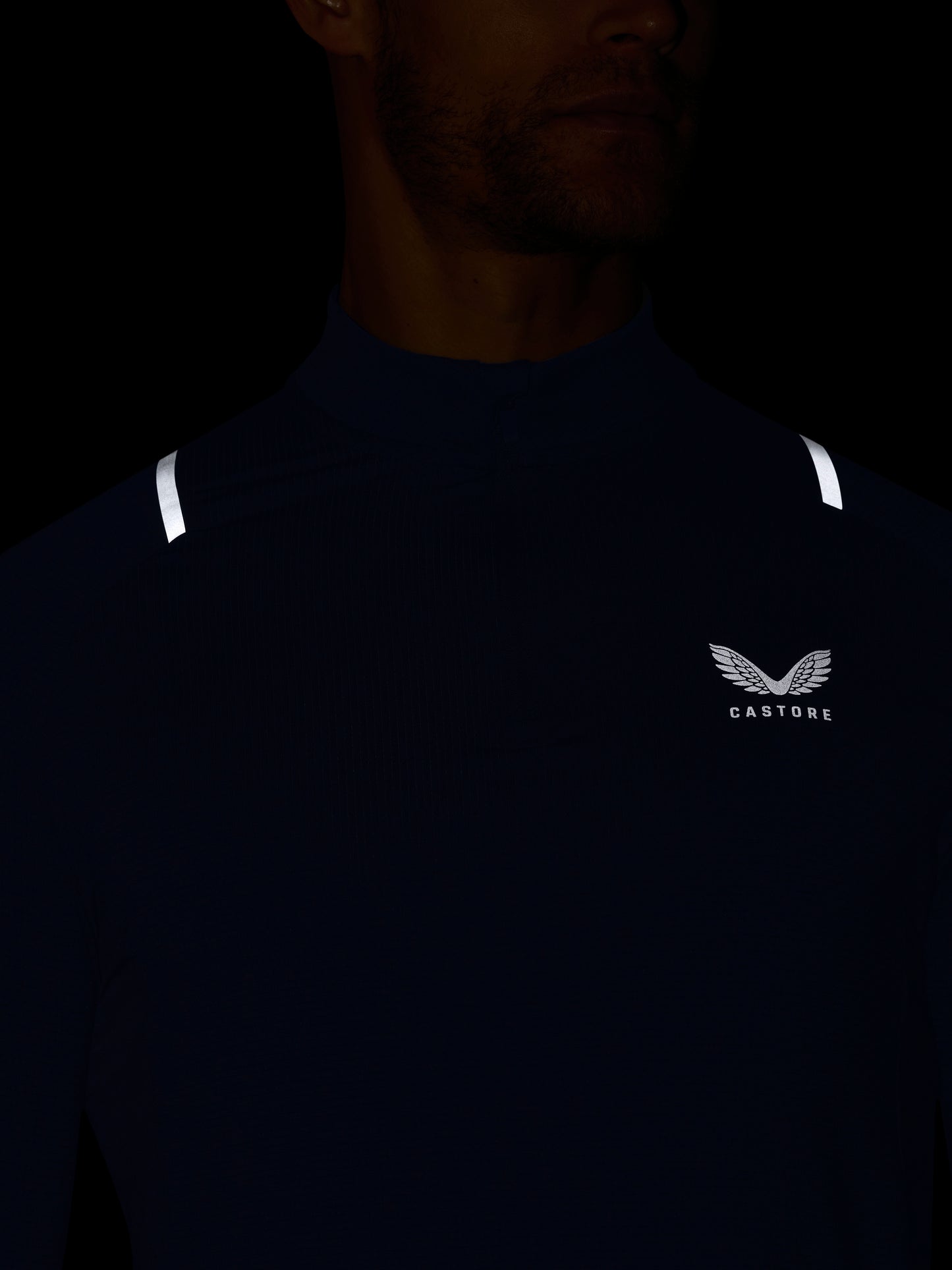 Dark blue athletic shirt with a logo on a black background