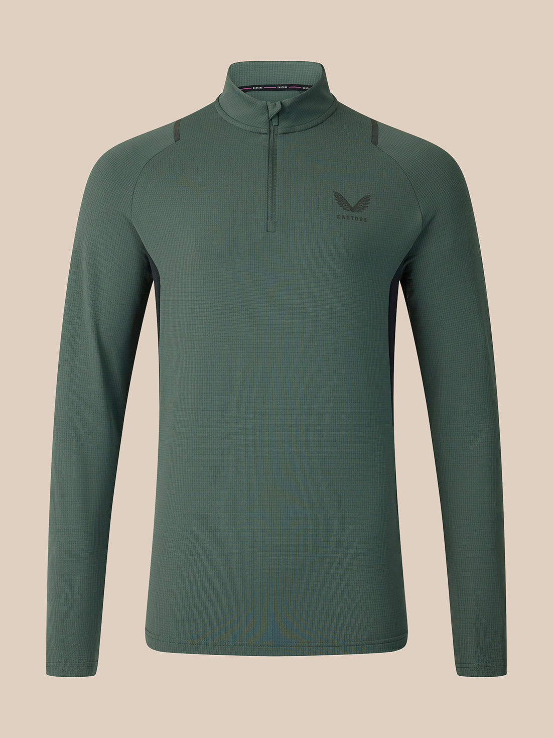 A dark green long-sleeve quarter-zip athletic top with a small wing logo on the left chest, displayed on a neutral beige background.