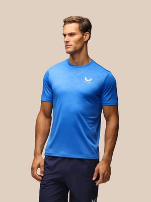 Male model wearing a blue Adapt short sleeve tee with a subtle geometric print.