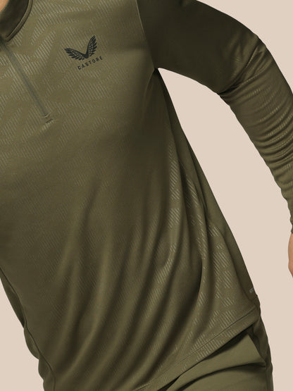 Green athletic shirt with Adidas logo on a beige background