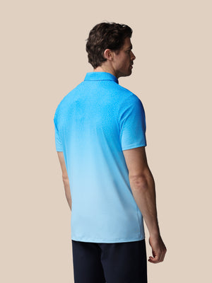 Man wearing a blue polo shirt on a beige background