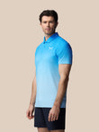Male model wearing blue map printed short sleeve polo with collar and a white logo on the chest.