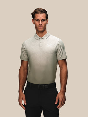 Male model wearing a cream golf short sleeve polo with a subtle geometric pattern across the chest