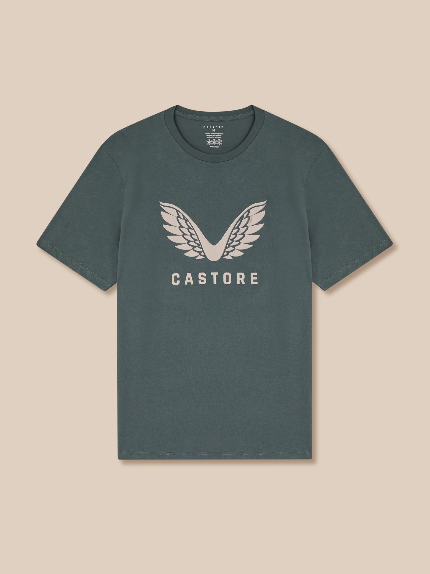 Gray t-shirt with 'Castore' logo on a beige background