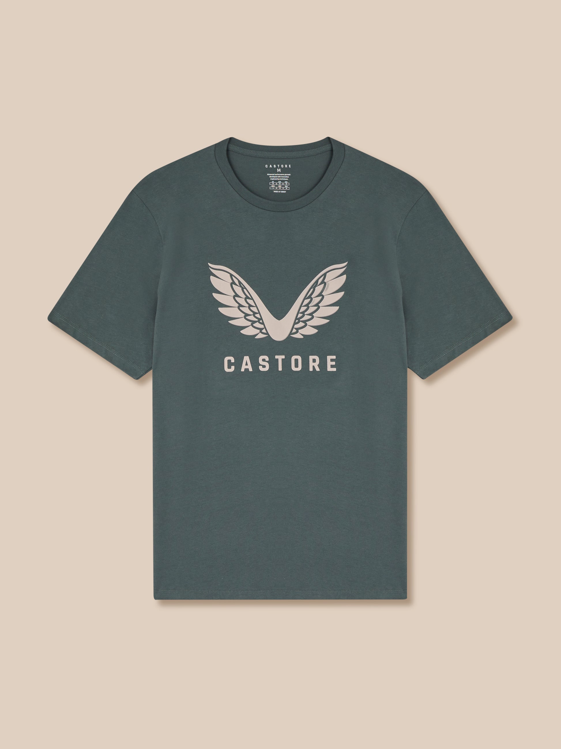 Gray t-shirt with 'Castore' logo on a beige background