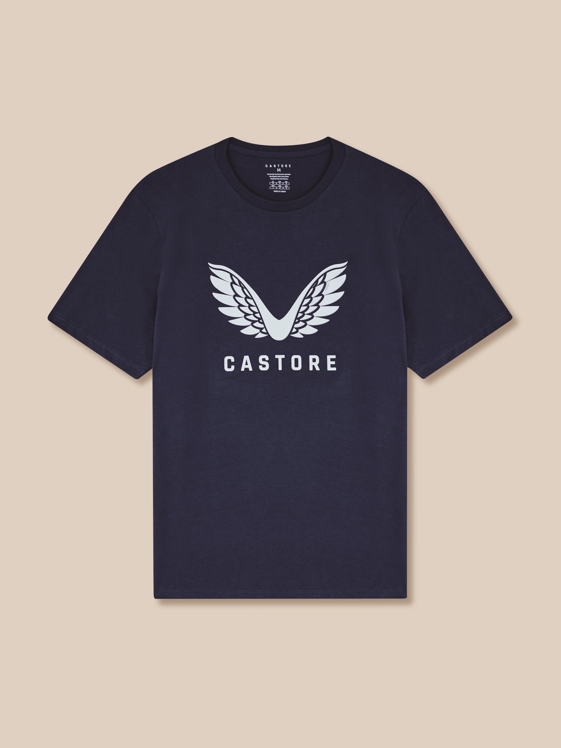 Navy blue t-shirt with white 'Castore' logo on a beige background