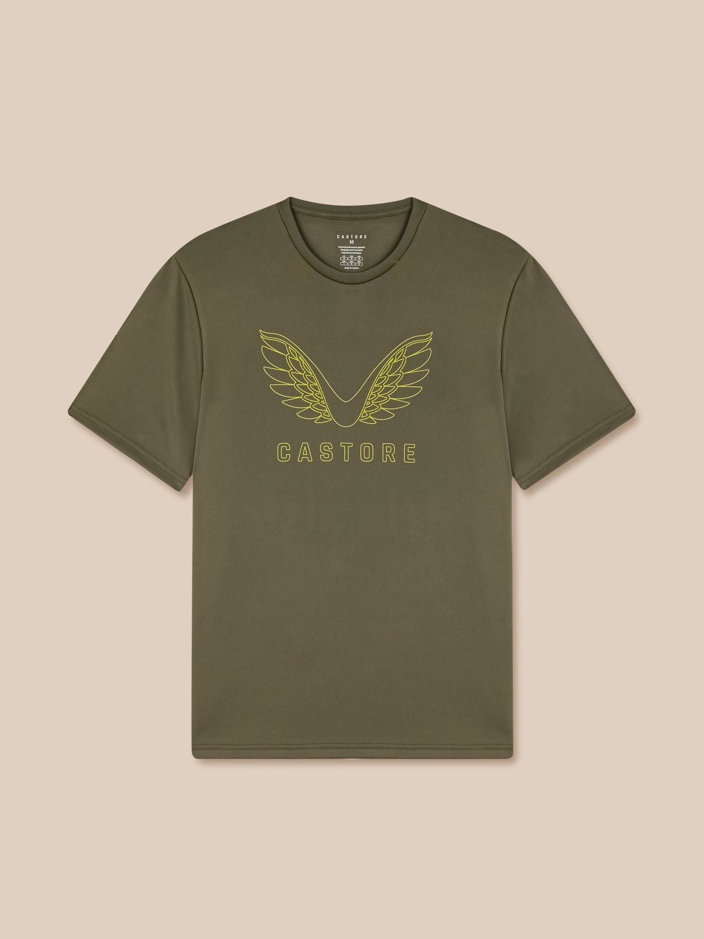 Green t-shirt with winged logo on a beige background