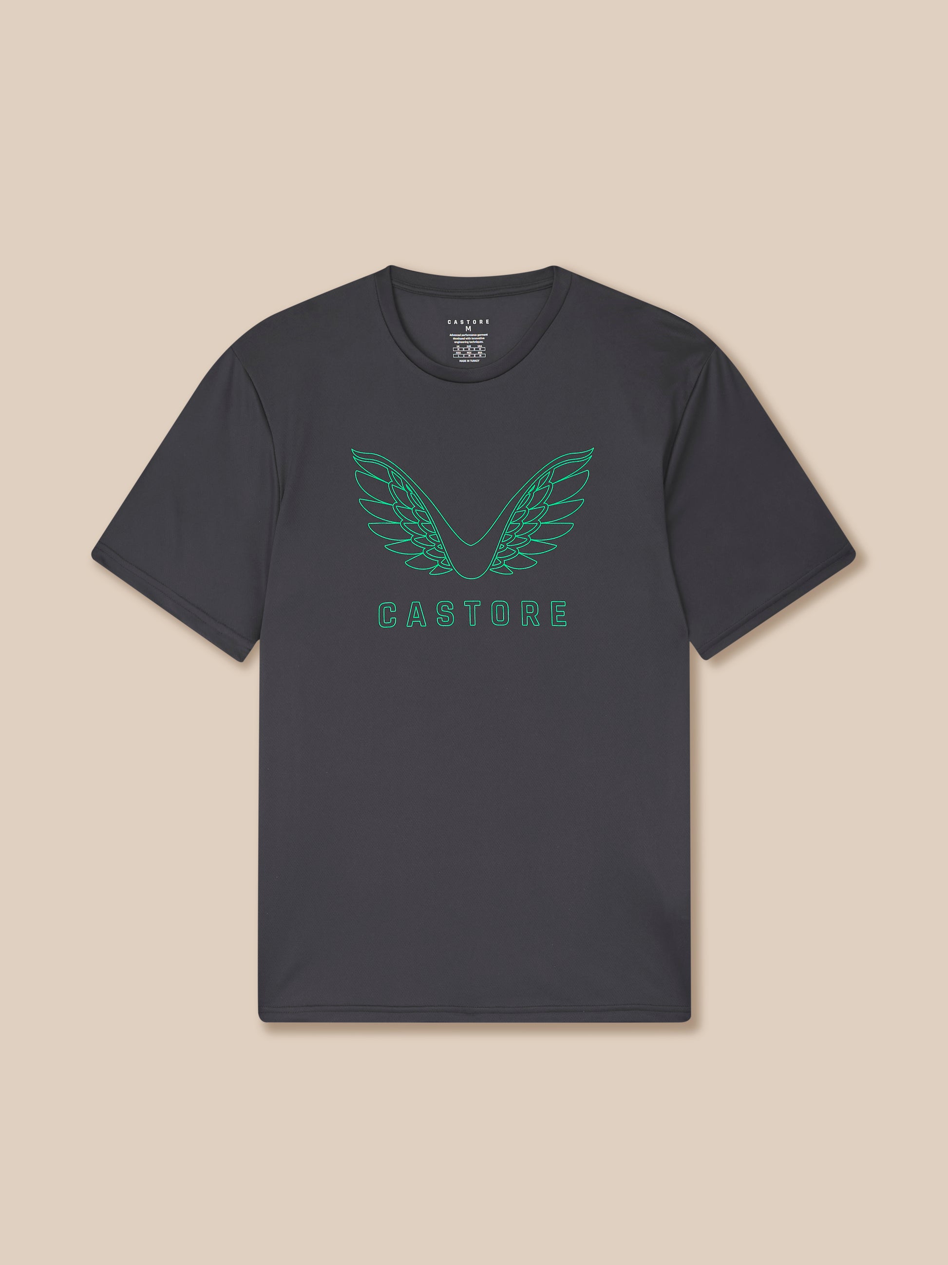 Black t-shirt with green logo and text on a beige background